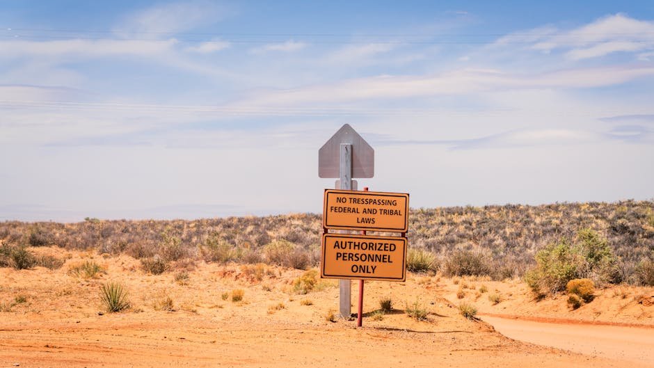 A striking desert scene in Arizona features a no trespassing sign under the expansive blue sky.