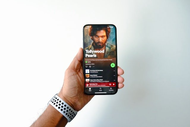 a person holding up a phone with a video game on it