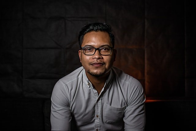 man in gray dress shirt wearing black framed eyeglasses
