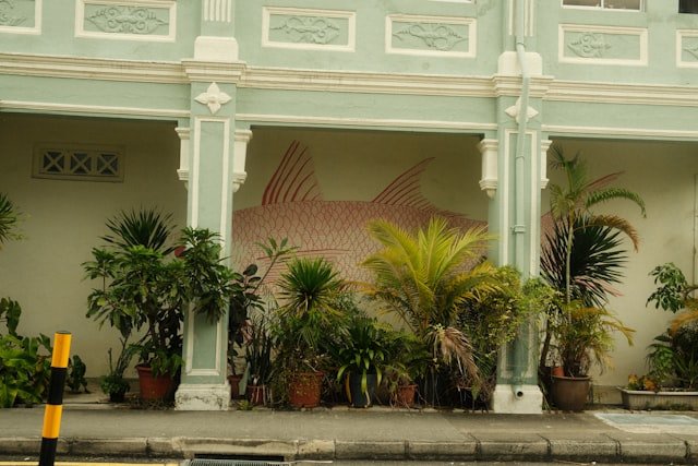 A large building with a mural of a fish on the side of it