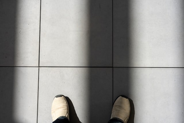 a person standing in front of a tiled wall