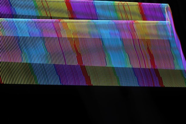 A close up of a multicolored object on a black background