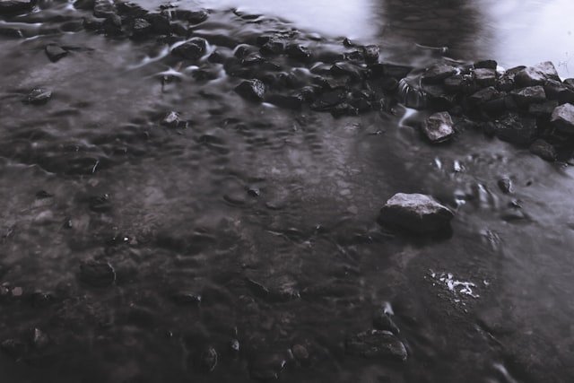 brown rocks on body of water