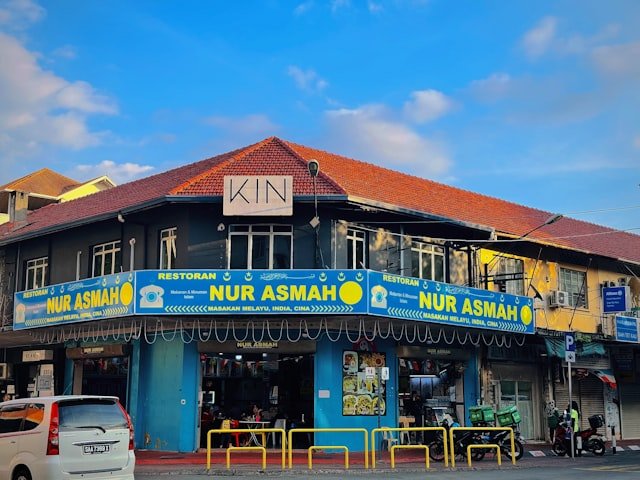 a blue and yellow building on a street corner