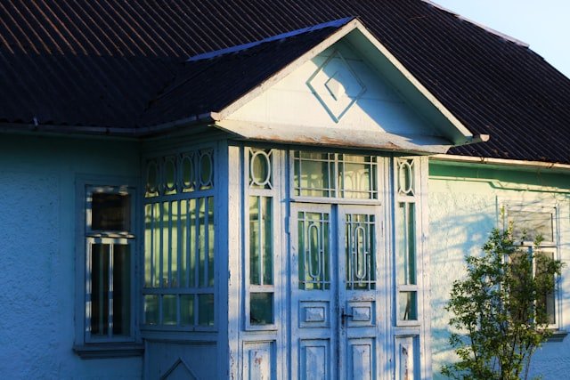 A blue house with intricate details is shown.