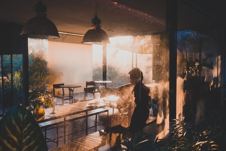A serene moment in a café bathed in warm sunset light in Semarang, Indonesia.