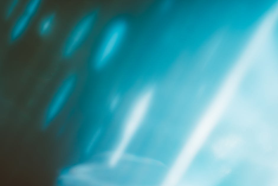 A vibrant and dynamic abstract blue gradient background with smooth textures and glowing effects.