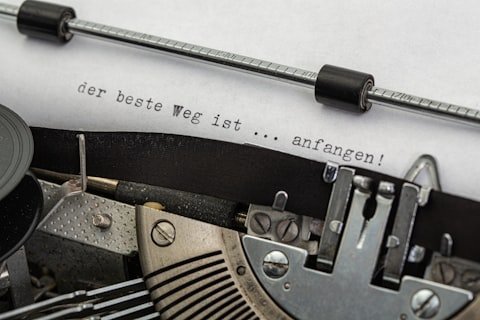 black and gray typewriter on white printer paper