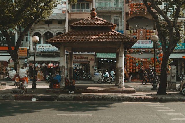 a group of people sitting on a bench in front of a building